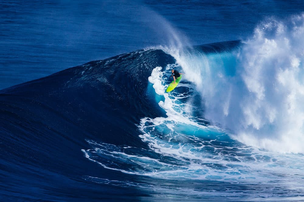 Surfer riding huge wave Jaws, in the USA