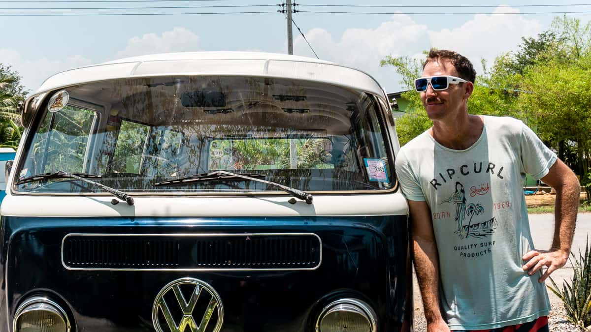 Man wearing quality sunglasses with Zeiss lenses (polarized) standing next to VW van