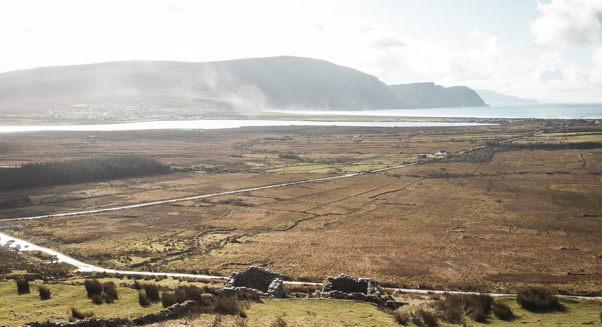 view from the deserted village on achill island, county mayo, ireland. the view faces out over the sea cliffs and keel beach on a misty, overcast but bright day.