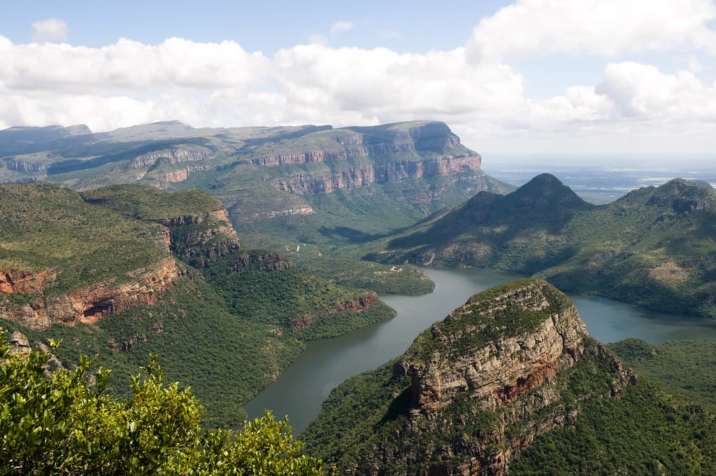 the blyde river canyon in africa on a hazy blue sky day.