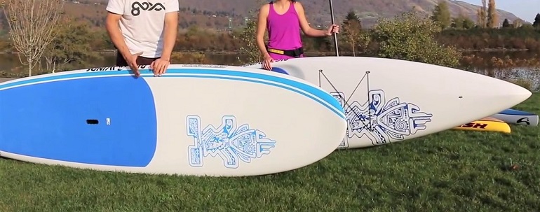 surfboard with paddle standing